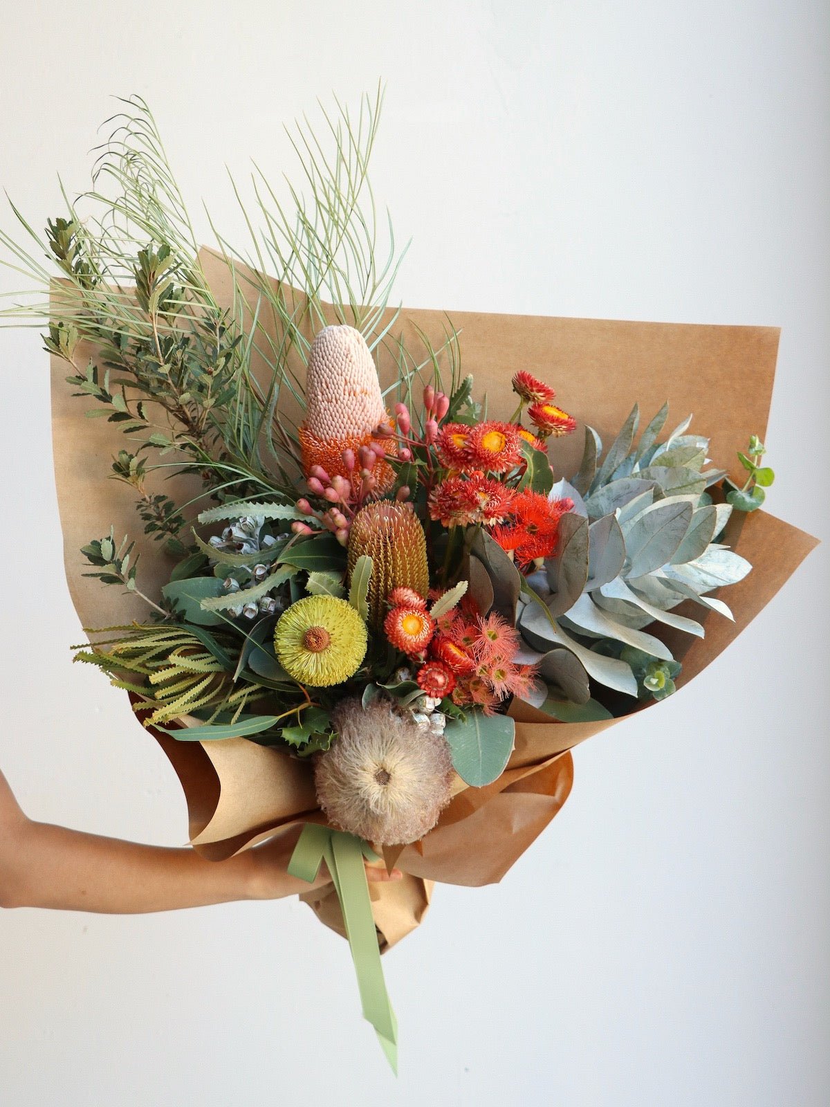 A Large size Australian native bouquet of flowers. The flowers include possum banksia, banksia menziesii, banksia prinotes, paper daisies, macrocarpa and flowering gum.
