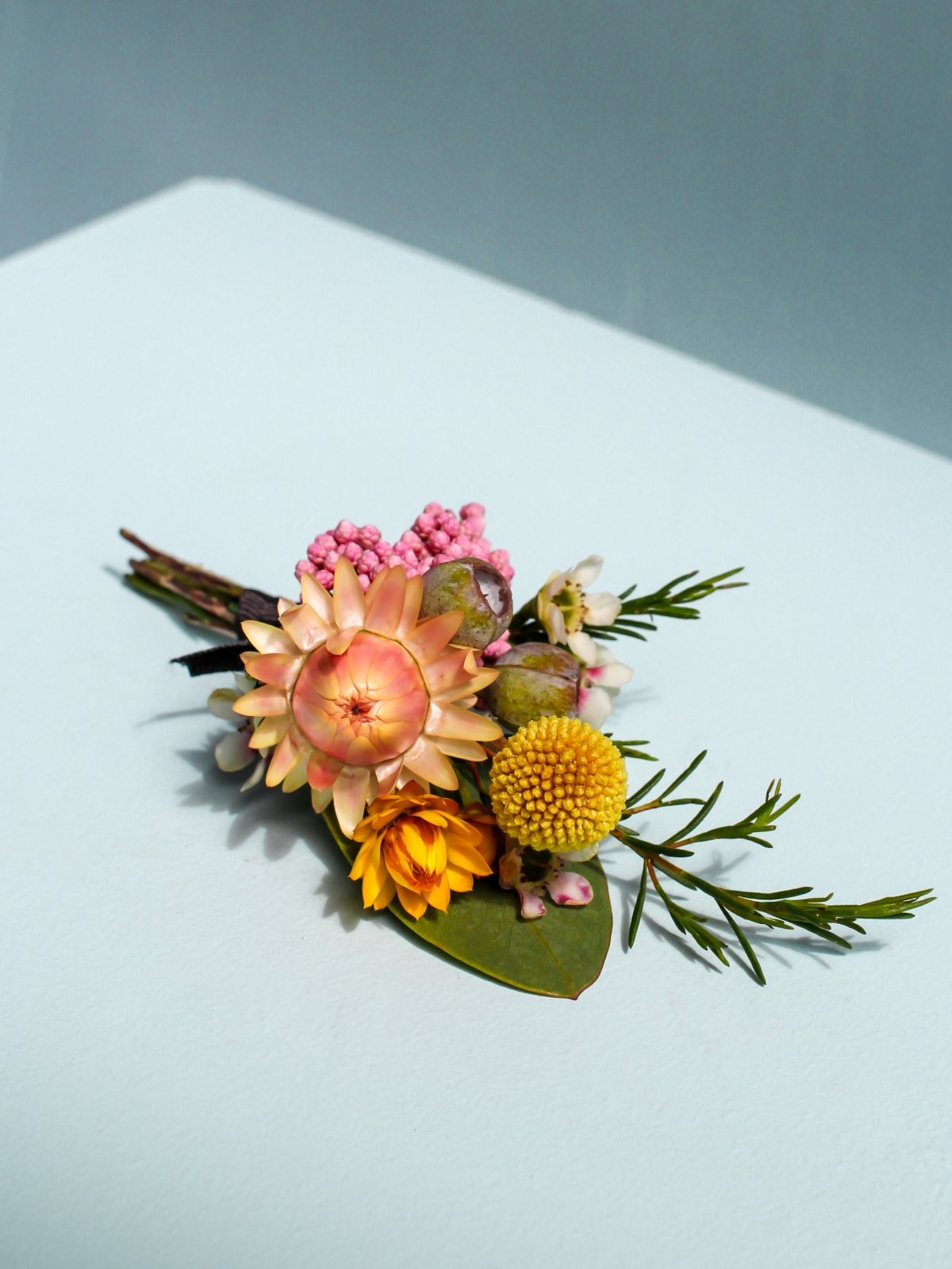 A Seasonal Wedding Buttonhole. Made using Australian Native flowers such as Strawflower, Billy Buttons, Eucalyptus, Riceflower and Geraldton wax. 